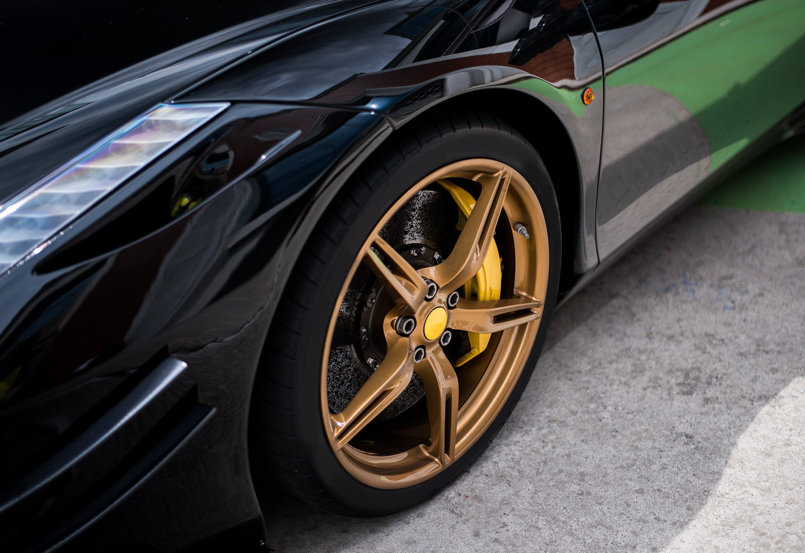 roue-de-voiture-berline-noire-a-decor-dore-couleur-bronze-min