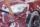 voiture-rouge-lavee-dans-lave-auto-libre-service-detail-brosse-se-deplacant-capot-avant-au-dessus-roues-laissant-traits-dans-du-savon-blanc_692357-6909